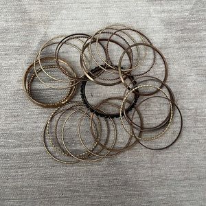Used 24  bracelets  gold and black beads